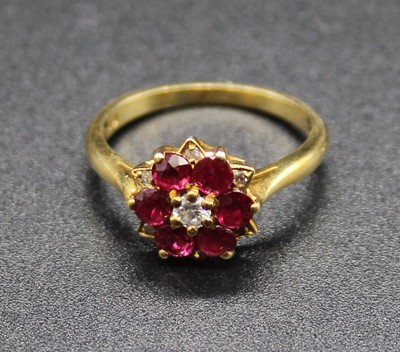 Lot 410 - An 18ct gold, ruby and diamond cluster ring...