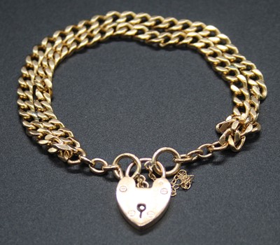 Lot 426 - A 9ct gold curblink double bracelet, with...