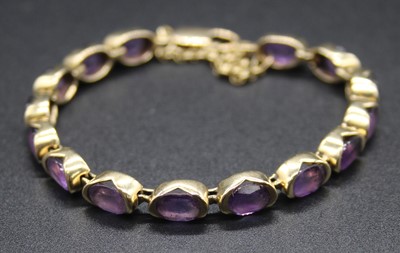 Lot 428 - A 9ct gold and amethyst bracelet, arranged as...