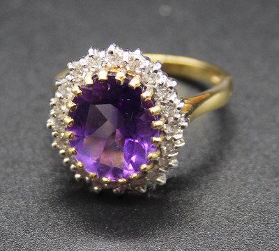 Lot 462 - An 18ct gold, amethyst and diamond cluster...