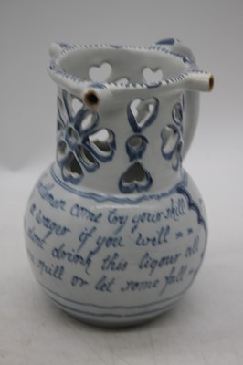 Lot 216 - An 18th century Liverpool Delftware puzzle jug,...
