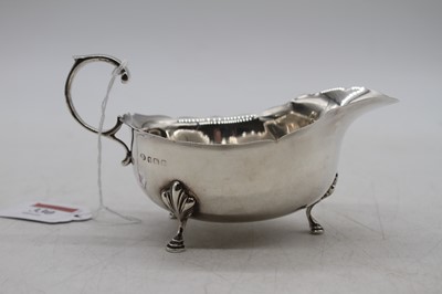 Lot 330 - A George V silver sauce boat having wavy rim...