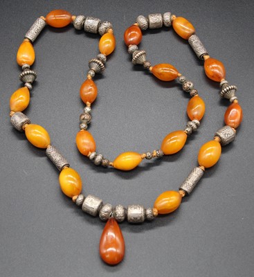 Lot 490 - A faux amber and white metal beaded and...