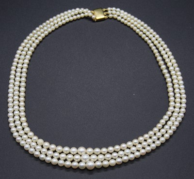 Lot 492 - A cultured pearl triple string necklace on 9ct...