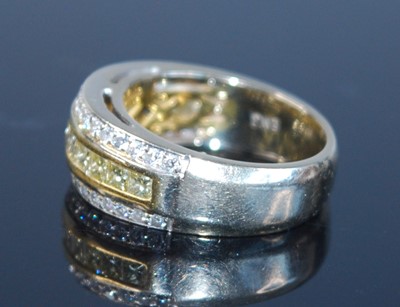 Lot 2677 - A yellow metal fancy yellow diamond three-row...