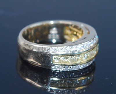 Lot 2677 - A yellow metal fancy yellow diamond three-row...