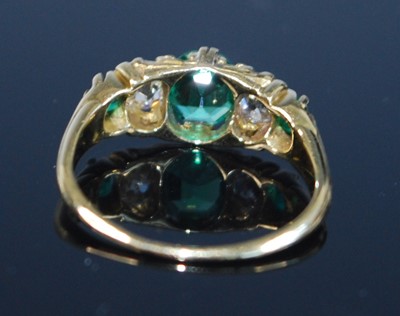 Lot 2357 - A yellow metal, emerald and diamond five stone...