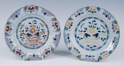 Lot 2065 - A pair of English polychrome delftware plates,...
