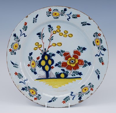 Lot 2103 - An English polychrome Delftware charger,...