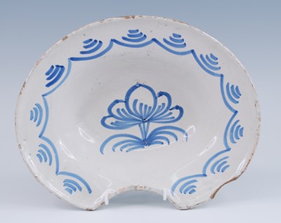 Lot 2126 - A French blue and white faience barber's...