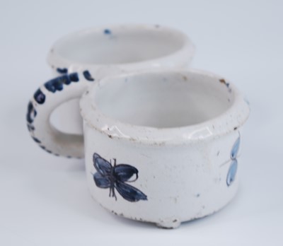 Lot 2167 - A Delft polychrome two bottle cruet stand,...
