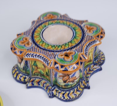 Lot 2129 - A French polychrome faience chamber stick,...