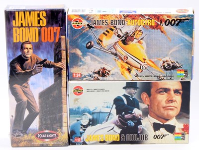 Lot 987 - A collection of James Bond related plastic...