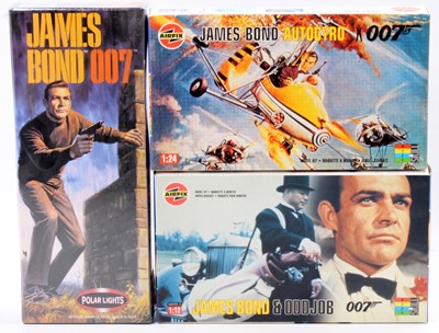 Lot 986 - A collection of James Bond related plastic...