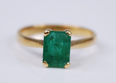 Lot 2313 - A yellow metal emerald single stone ring, the...