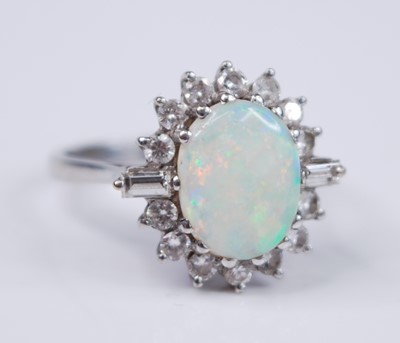 Lot 2334 - A white metal, opal and diamond oval cluster...