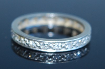 Lot 2312 - A white metal diamond full hoop eternity ring,...