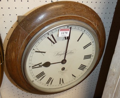 Lot 1179 - An oak cased circular wall clock, the white...