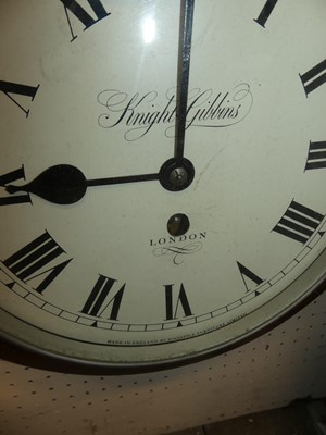 Lot 1179 - An oak cased circular wall clock, the white...