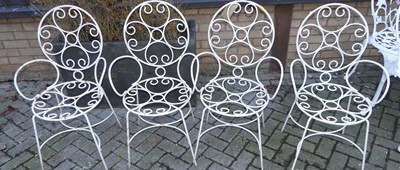 Lot 1189 - A set of four white painted wired metal garden...