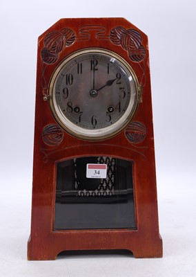 Lot 34 - An Arts & Crafts walnut mantel clock, the...