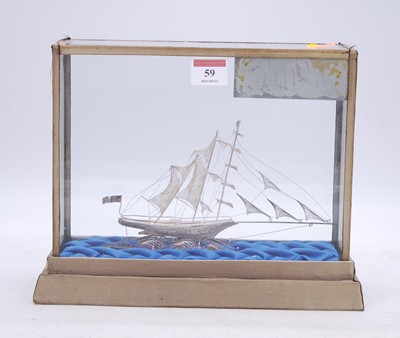 Lot 59 - A filigree work model of a ship, housed in a...