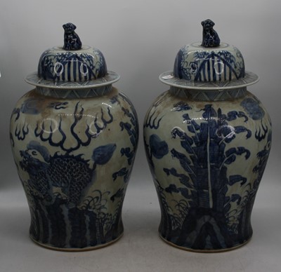 Lot 91 - A pair of Chinese blue and white glazed temple...