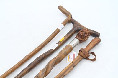 Lot 131 - A walking stick, the handle carved in the form...