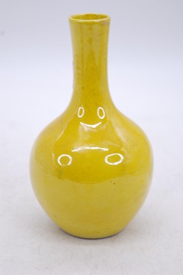 Lot 201 - A Chinese yellow glazed bottle vase, zhuanshu...