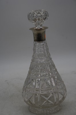 Lot 248 - A crystal decanter, having silver collar, h.27....