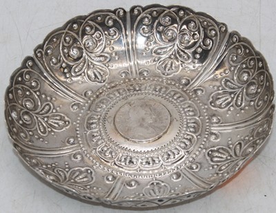 Lot 249a - A repousse decorated white metal dish, inset...