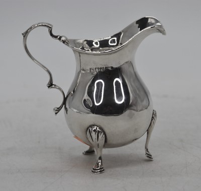 Lot 304 - A Victorian silver milk jug, standing upon...