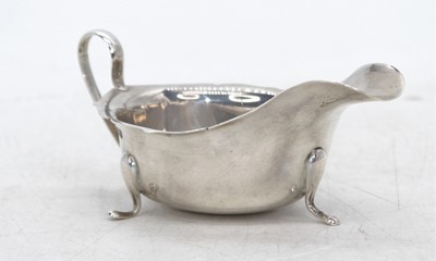 Lot 301 - A George V silver sauceboat, of helmet form,...