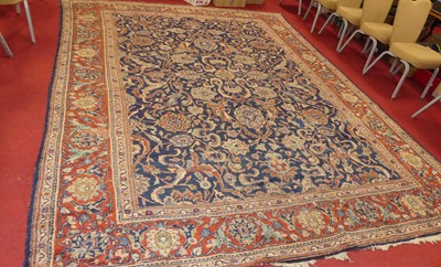 Lot 1196 - A large Persian woollen blue ground Tabriz rug,...