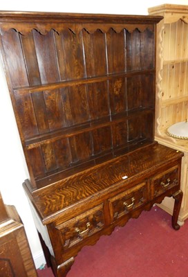 Lot 1211 - An early 20th century geometric oak dresser,...