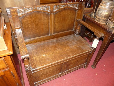 Lot 1234 - An early 20th century joined oak two-seater...