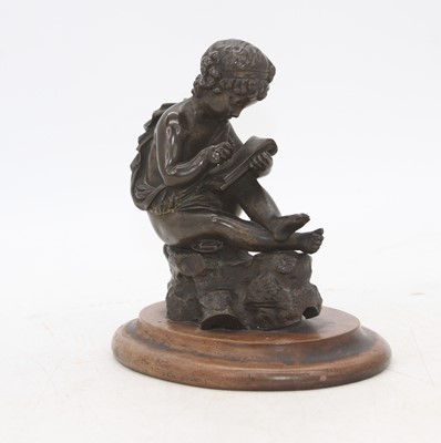 Lot 467 - A bronze figure of a child, shown in seated...