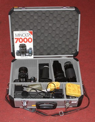 Lot 543 - A Minolta 7000 SLR camera, cased with various...