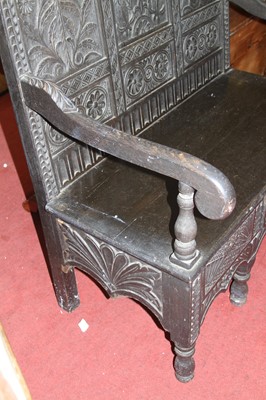 Lot 1423 - An ebonised, joined, and relief carved oak...