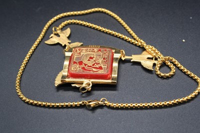 Lot 312 - An Egyptian Revival gilt metal pendant on neck...