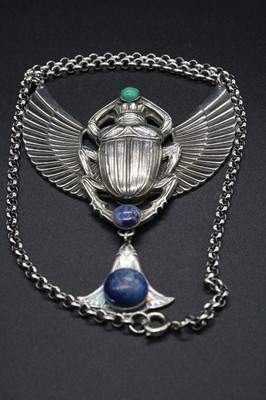 Lot 320 - A metal and hardstone set pendant as a winged...