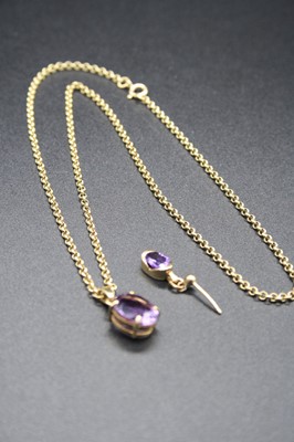 Lot 323 - A 9ct gold amethyst pendant, the oval cut four-...