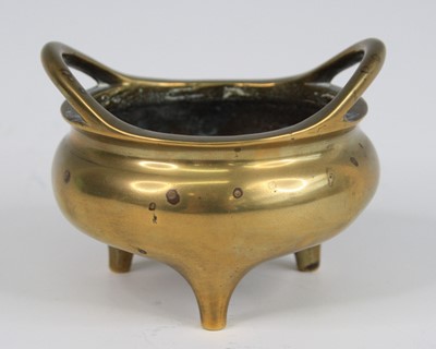 Lot 2543 - A Chinese gilt bronze tripod censer, having...