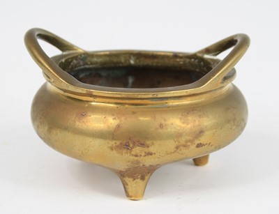 Lot 2544 - A Chinese gilt bronze tripod censer, having...