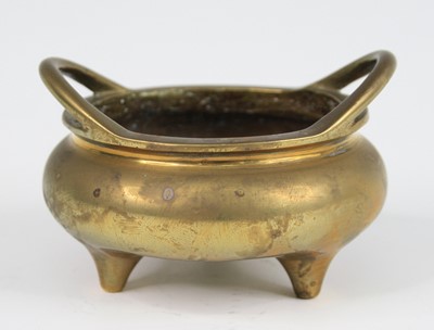 Lot 2544 - A Chinese gilt bronze tripod censer, having...