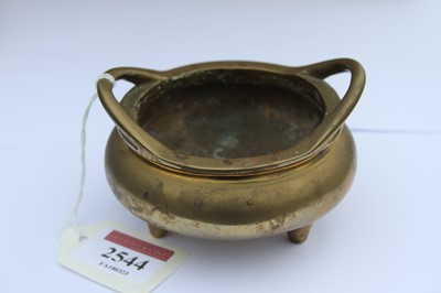 Lot 2544 - A Chinese gilt bronze tripod censer, having...
