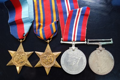 Lot 636 - A collection of four WW II medals, to include...