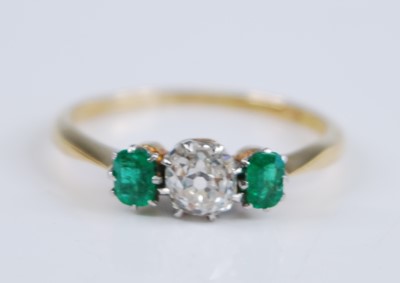 Lot 2355 - A yellow and white metal, emerald and diamond...