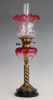 Lot 2520 - A Victorian brass oil lamp, the cranberry...