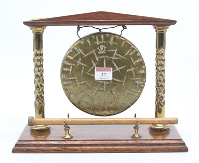 Lot 27 - A Burmese oak and brass table gong, height 24cm